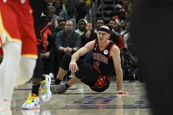 Chicago Bulls guard Alex Caruso (6) sits on the court after being knocked over against the Atlanta Hawks 